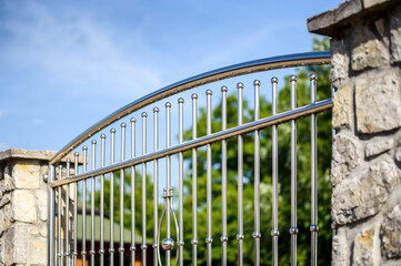 Chrome fence . Chromium Stainless steel fence on stone wall
