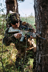 	
Soldier in a forest hiding in a foliage. Full equipment. soldier concept	
