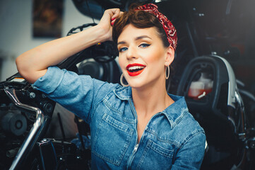 Plakat beautiful woman posing near a motorcycle