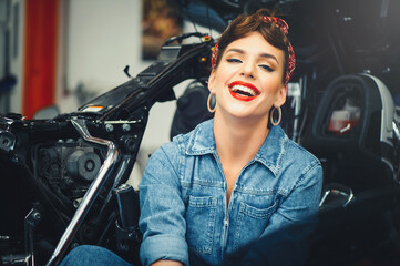 Plakat beautiful woman posing near a motorcycle