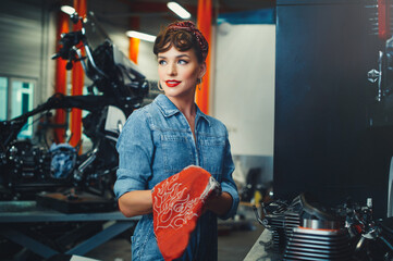 beautiful girl repairs a motorcycle in a workshop, pin-up style, service and sale