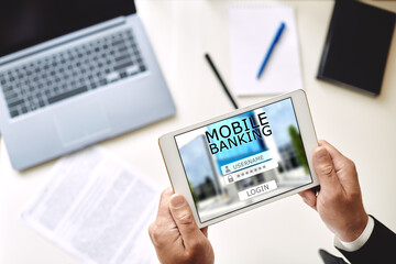 mobile banking concept. man uses bank mobile application using tablet