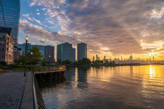 Dramatic Amazing Sunrise Over Hoboken, NJ Featuring Hudson River And Waterfront On The Foreground And Manhattan, NY On The Background