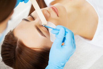 Young woman in a beauty studio on an eyelash extension procedure