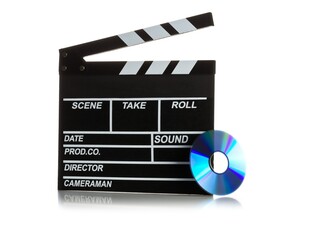 Fototapeta premium Single, black, open movie clapper or clapper-board with dvd movie disc on white - digital movie, home cinema or movie night concept