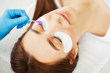 Young woman in a beauty studio on an eyelash extension procedure