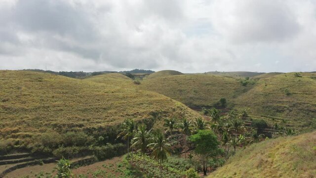 Panoramic Aerial Shot of Teletubbies Hills in Bali, Indonesia with Cloudy Skies