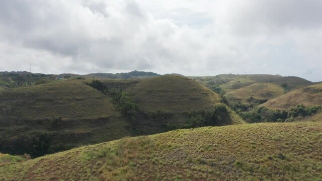 Drone Shot of White Clouds and Tropical Savannah Hills in Bali, Indonesia