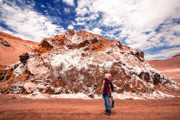 Atacama desert valle de la Luna moon valley in day time with red and white landscape and blue sky and white clouds with model