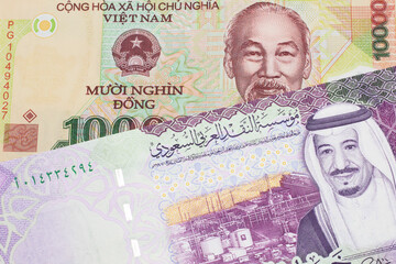 A colorful ten thousand dong note from Vietnam close up in macro with A colorful, five Saudi riyal...