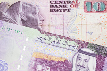 A ten Egyptian pound bill with A colorful five riyal note from Saudi Arabia close up in macro