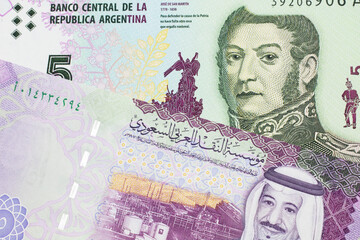 A five peso bill from Argentina, close up in macro with a colorful five riyal bank note from Saudi...
