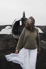girl in a white dress near the abandoned plane