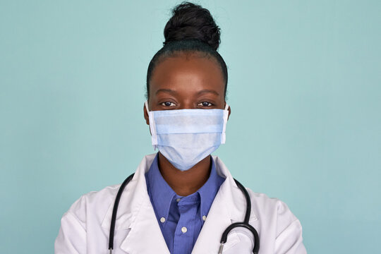 African American Female Doctor Wear White Medical Coat Stethoscope Face Mask Look At Camera Closeup Headshot Portrait. Brave Proud Black Hero Physician On Grey, Healthcare Safety, Medicine Protection