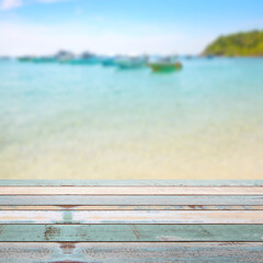 Fototapeta premium Wood table top with blurred nature scene tropical beach