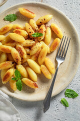 Homemade potato dumplings fried in pan with butter