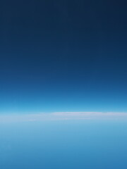 Obraz premium At sea, Japan-June 23, 2020: View of horizon from the window in the airplane 