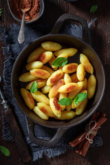 Hot potato dumplings served with sugar and cinnamon