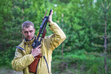 A man with a crossbow in his hands.