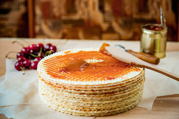 cooking waffle cake, step by step, with condensed milk,and decorated cherries