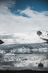 Naklejka na ściany i meble Beautiful view of icebergs in Jokulsarlon glacier lagoon, Iceland, global warming and climate change concept