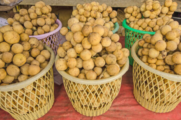 Plastic basket of southern langsat fruits