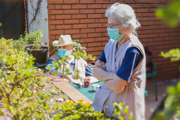 elderly couple on terrace during coronavirus epidemic quarantine