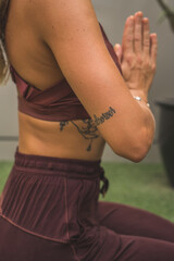 Woman with tattoos doing yoga
