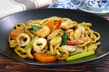 Stir fried noodle with seafood. Hokkian (Hakka) noodle,  famous local food in Phuket Thailand