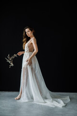 Portrait of a bride in a wedding dress holding a bridal bouquet in hands