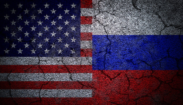 Grunge dual flags of Russia and United States on concrete wall with cracks to illustrate the tension and conflict between the two.