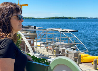 woman looking at lake at boat dock