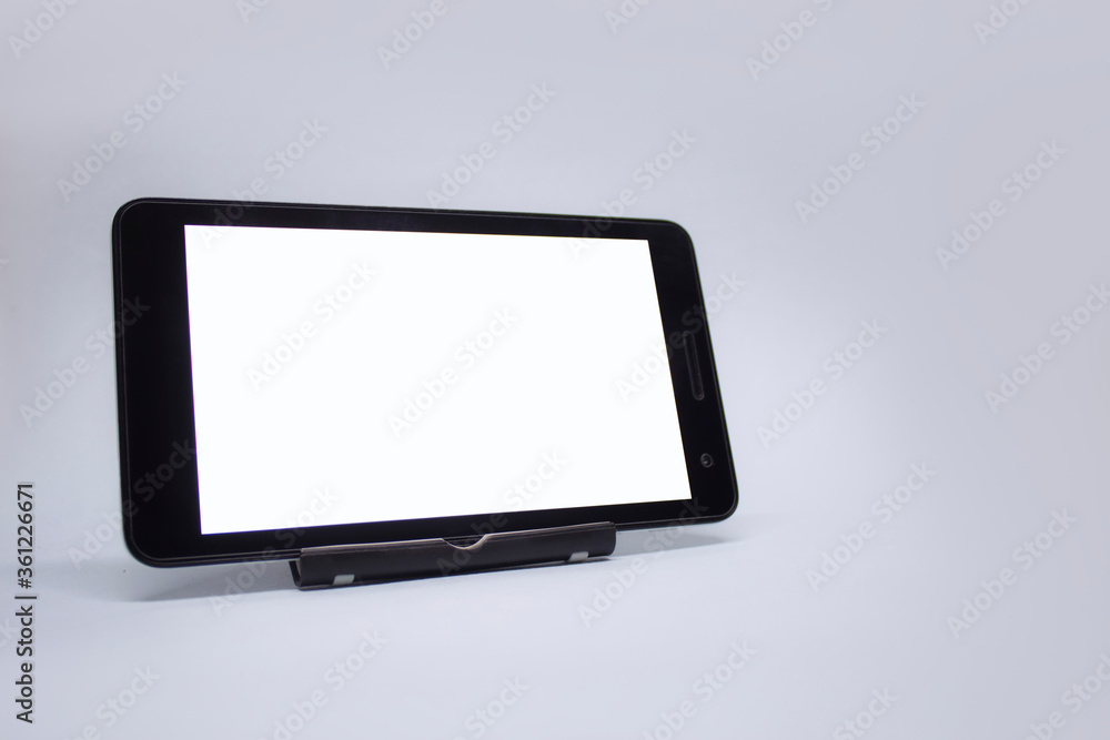 Poster mock up tablet with white display on a light background.
