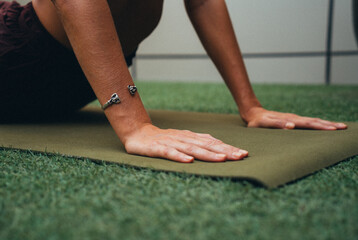 Female hands on the yoga mat