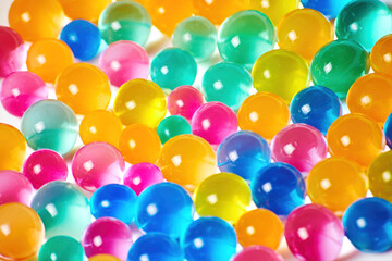 Fototapeta na wymiar Sweet jelly balls wallpaper background texture. Transparent candy balls scattered on the table. Colorful food backgrounds
