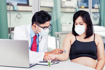 Physician checks heartbeat his pregnant patient