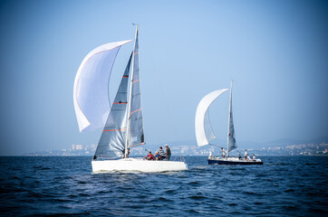 Fototapeta premium Sailing yacht race. Ship yachts with white sails in the open Sea. Luxury boats