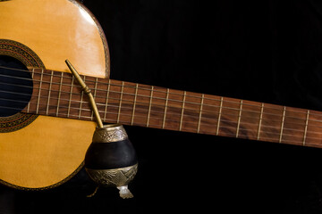 Mate and guitar, concept of Argentine folklore, isolated on black background