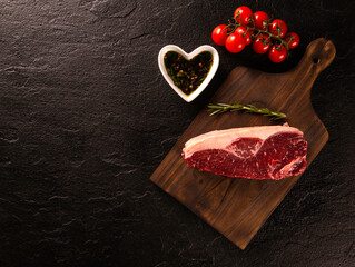Obraz na płótnie Canvas raw picanha steaks with spices on a dark background
