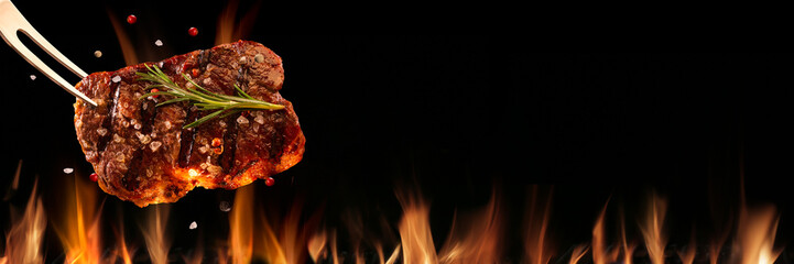 Fototapeta Beef steak falling on the grill with fire. Brazilian barbecue obraz