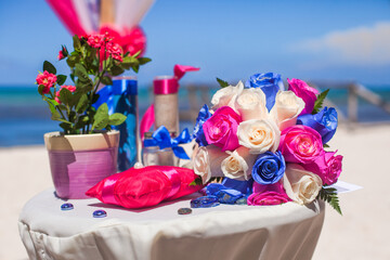 Bridal flowers bouquet on the sandy beach as decoration for tropical destination wedding ceremony 
