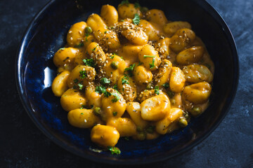 plant-based food, vegan pumpkin gnocchi with sesame seeds and coriander