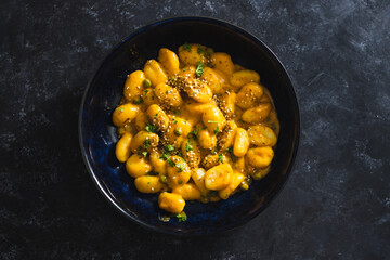plant-based food, vegan pumpkin gnocchi with sesame seeds and coriander