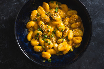 plant-based food, vegan pumpkin gnocchi with sesame seeds and coriander