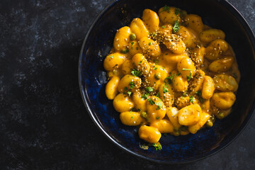 plant-based food, vegan pumpkin gnocchi with sesame seeds and coriander