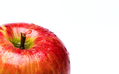 Variegated apple red and yellow with water drops on white background.  Partial View with copy space.
