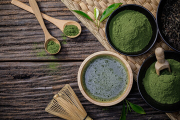 Japanese organic matcha green tea powder in bowl with wire whisk and green tea leaf on wooden background, Organic product from the nature for healthy with traditional style