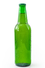 Cold refreshment and alcoholic beverages concept with picture of wet generic green bottle of beer without branding covered in water droplets isolated on white background with clipping path cutout