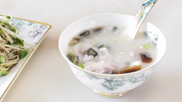 Chinese traditional food noodles and preserved egg and lean pork porridge