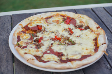 Close up of mediterranian pizza with meat topping.